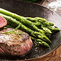 Venison steaks with buttered asparagus and red wine sauce